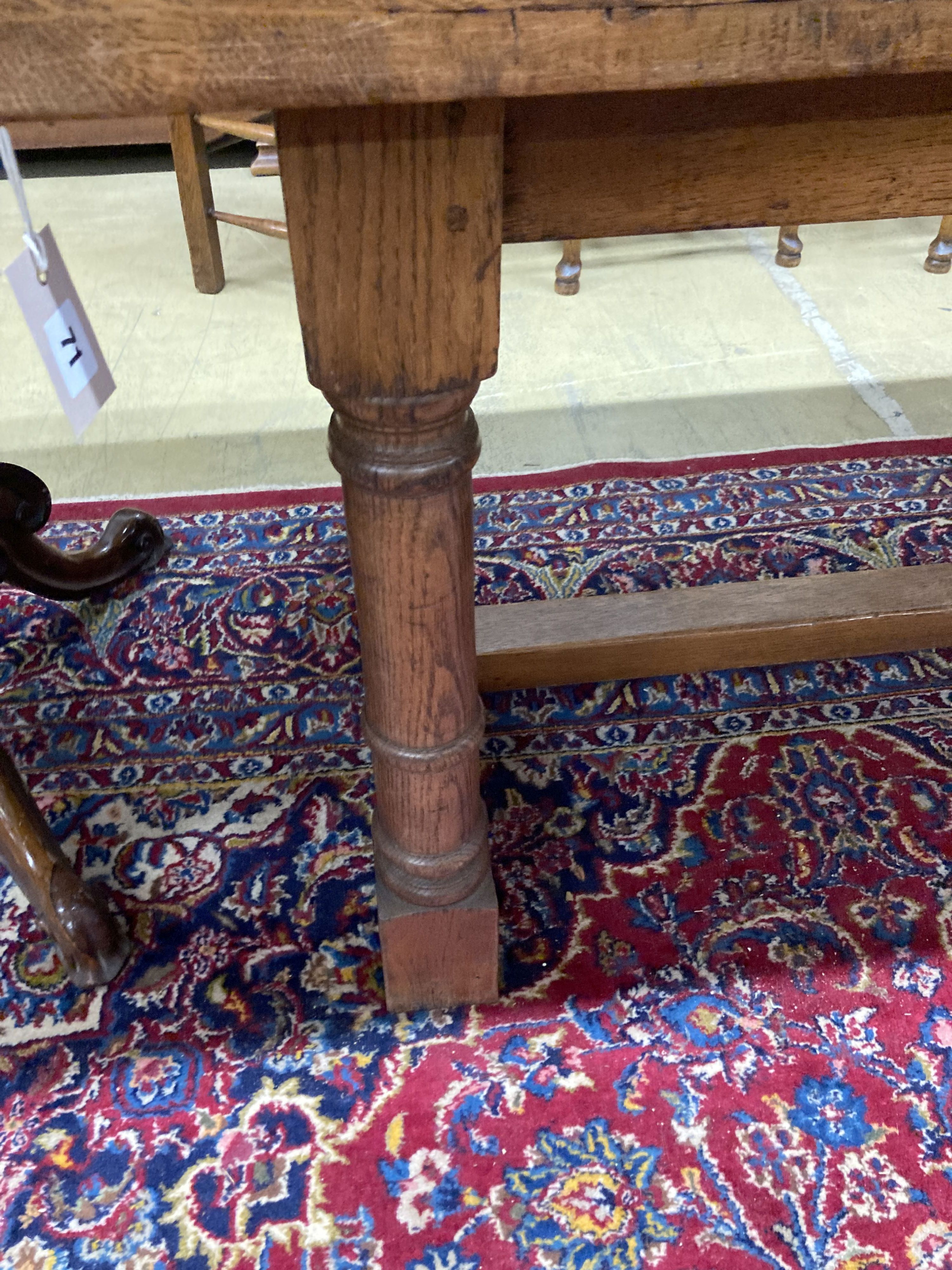 An 18th century style oak refectory dining table, length 214cm, depth 81cm, height 76cm